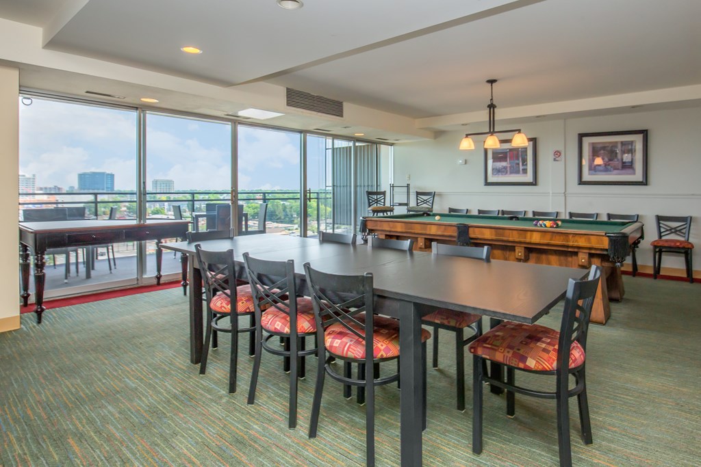 Resident lounge area with long table and billiards