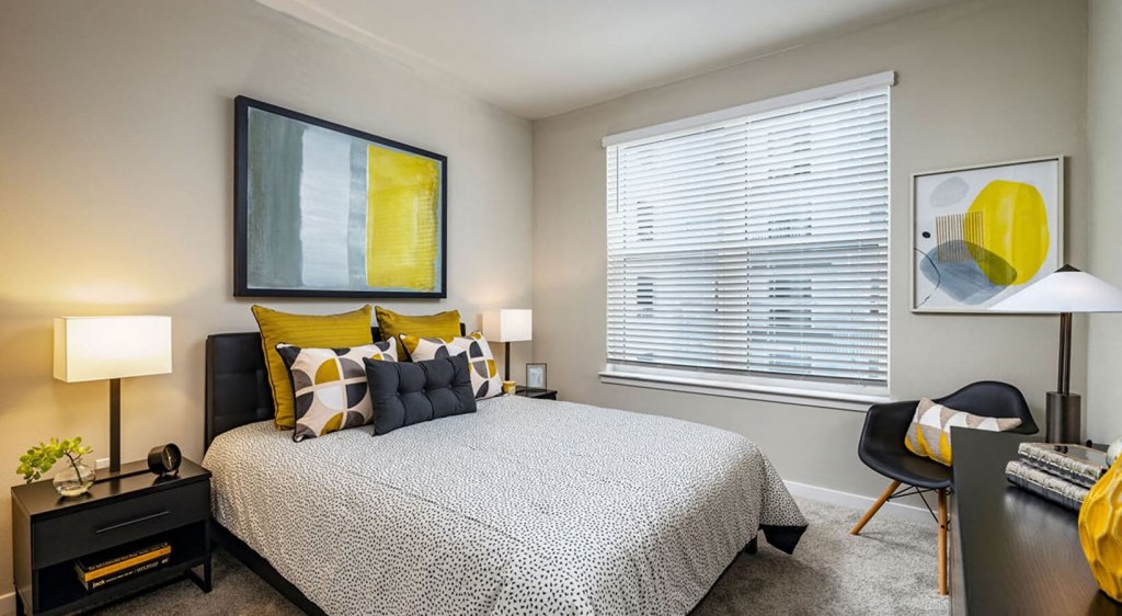 a bedroom with a bed and a large window