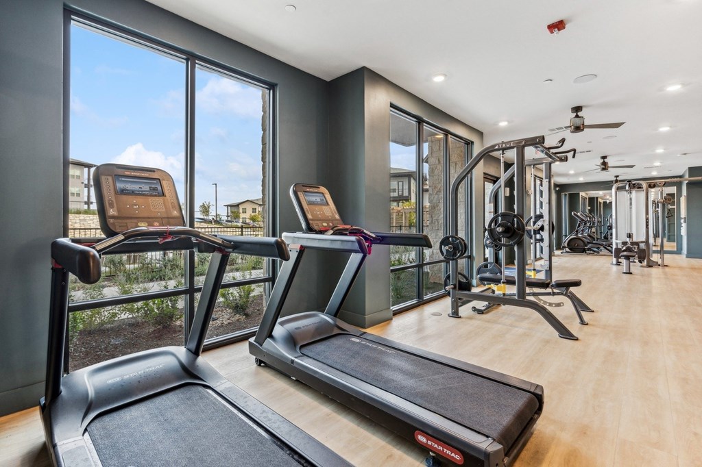 A gym with treadmills and other exercise equipment.