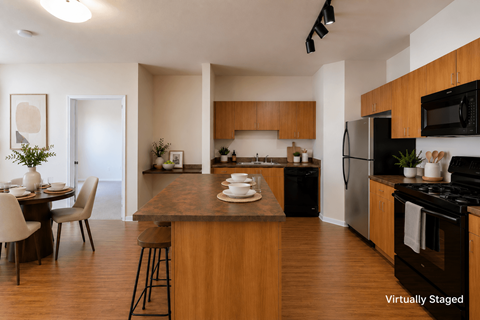 A kitchen with a dining table and chairs.