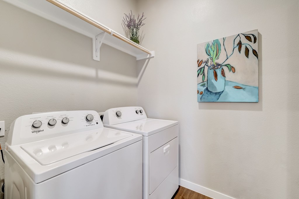 Laundry room with washer and dryer and a built in shelf.