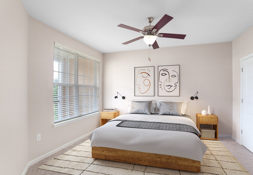 a bedroom with a large bed and a ceiling fan