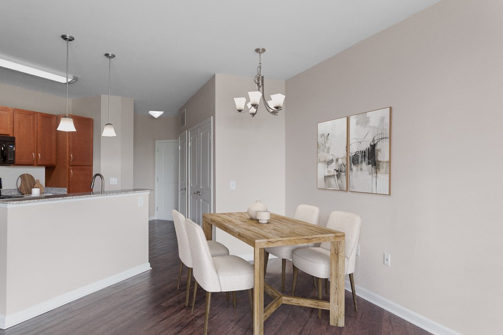a dining room with a wooden table and white chairs