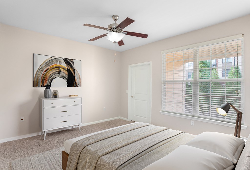 a bedroom with a bed and a ceiling fan