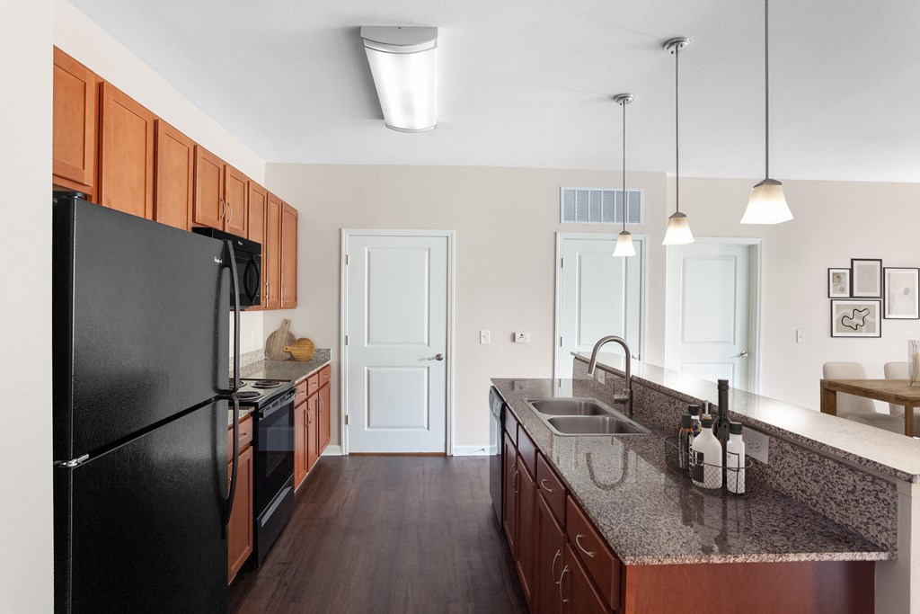 a kitchen with black appliances and granite counter tops