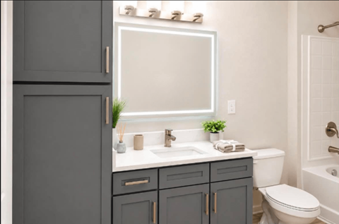 A bathroom with a white sink and a white toilet.