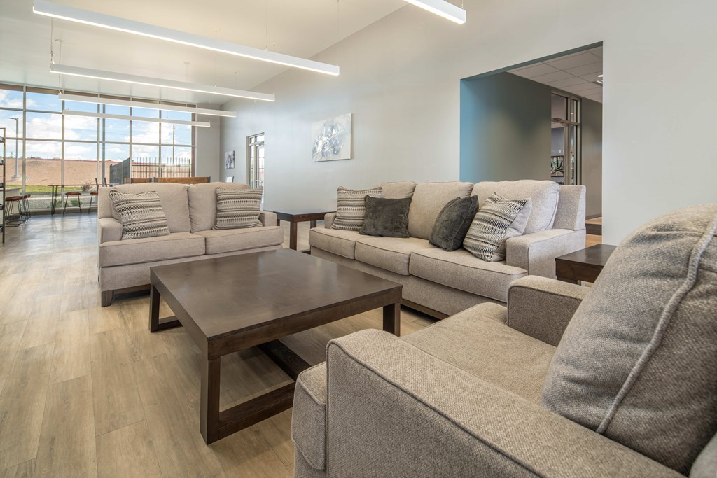 clubhouse lounge with a large couch and a coffee table.