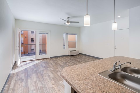 A kitchen with a sink and a fan.