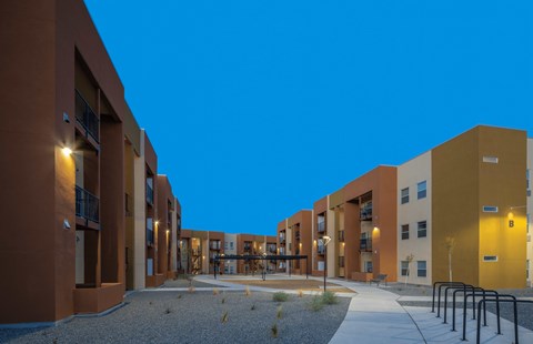 A modern apartment complex with a courtyard and pathway.