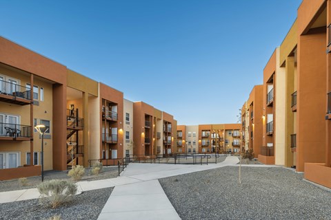 A modern apartment complex with a central courtyard and pathways.