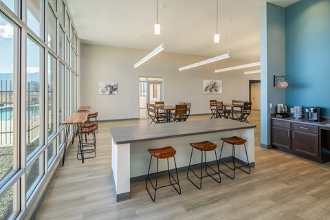 A kitchen with a bar area and a dining area in the clubhouse