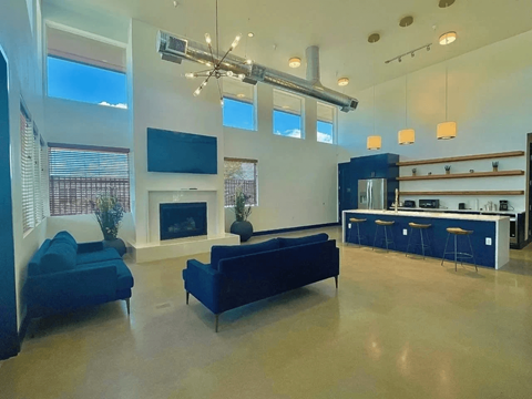 A modern living room with a fireplace and a bar area.