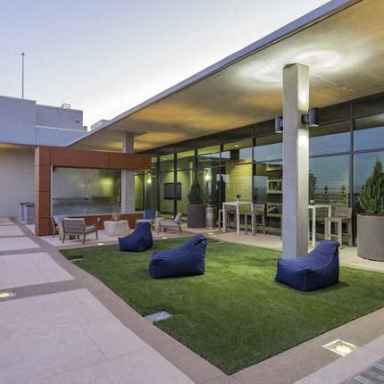 a house with blue pillows on the grass