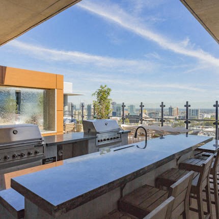 a rooftop kitchen with a view of the city