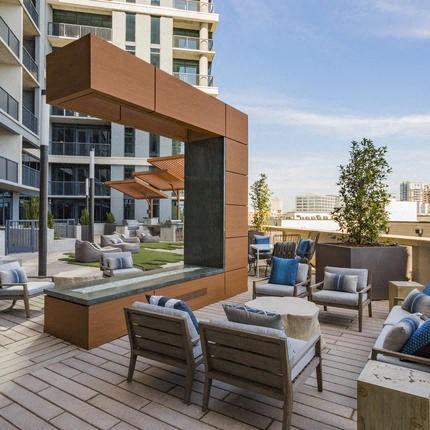 a patio with chairs and tables and a fountain