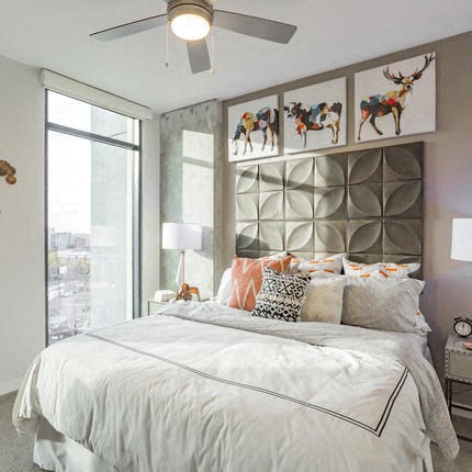 a bedroom with a bed and a ceiling fan