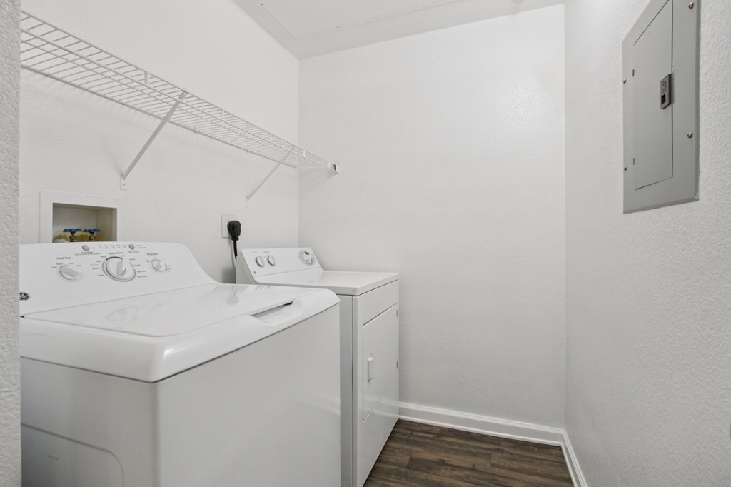 A small laundry room with a washer and dryer.