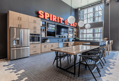 A modern kitchen with a wooden table and chairs.