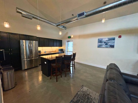 A kitchen with a dining table and chairs.