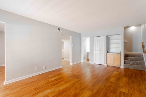 A room with wooden floors and white walls.