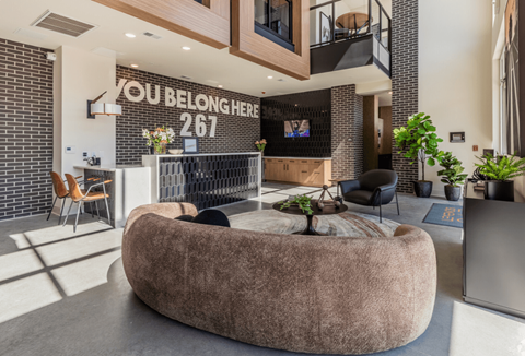 A modern living room with a large sofa and a flat screen TV.