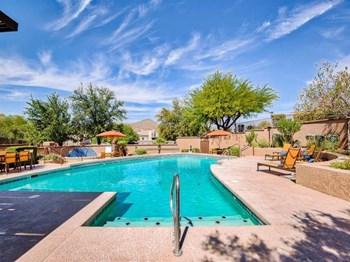 Sparkling swimming pool with lounge areas at Starrveiw at Starr Pass Apartments in Tucson, AZ