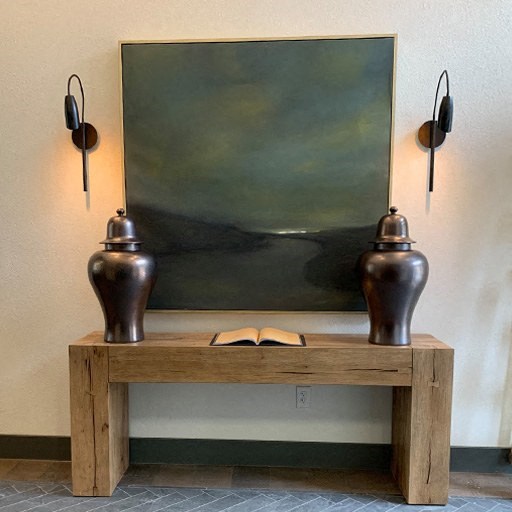 a painting and two vases on a table