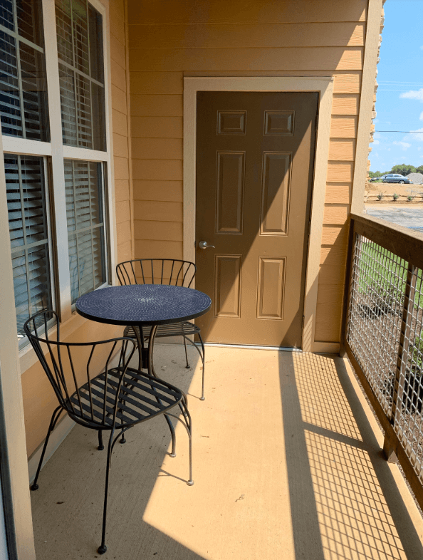 A patio with a table and chairs.