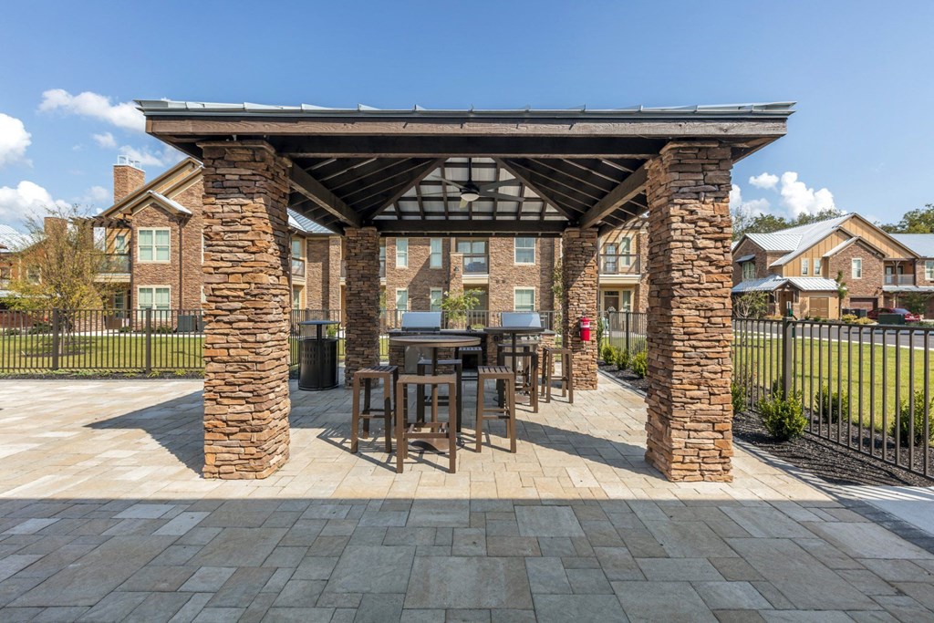 A covered patio area with a table and chairs.
