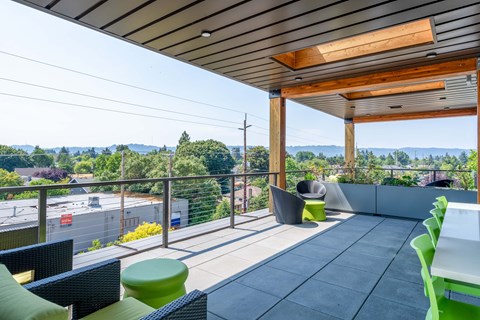a balcony with patio furniture and a view of the city