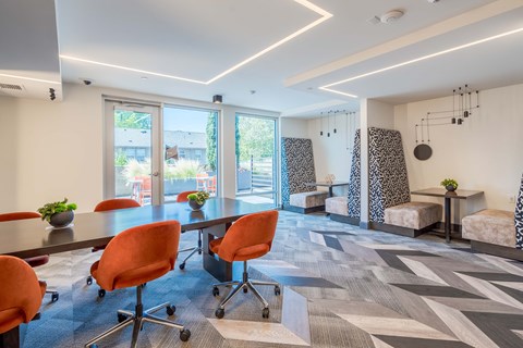 a conference room with a large table and chairs and a couch