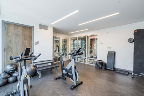 a gym with treadmills and other exercise equipment in a building with a staircase