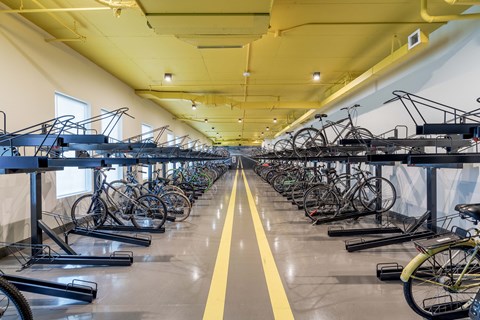 a long line of bikes parked on racks in a building
