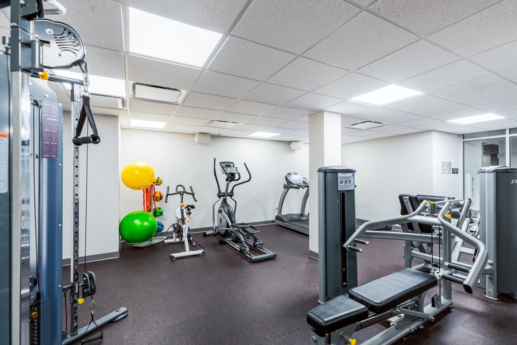 a gym with weights and other exercise equipment in a building