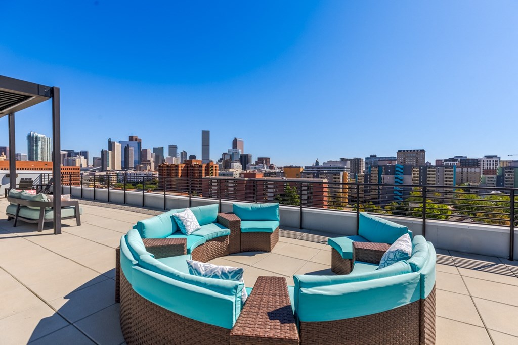 a rooftop patio with a view of the city