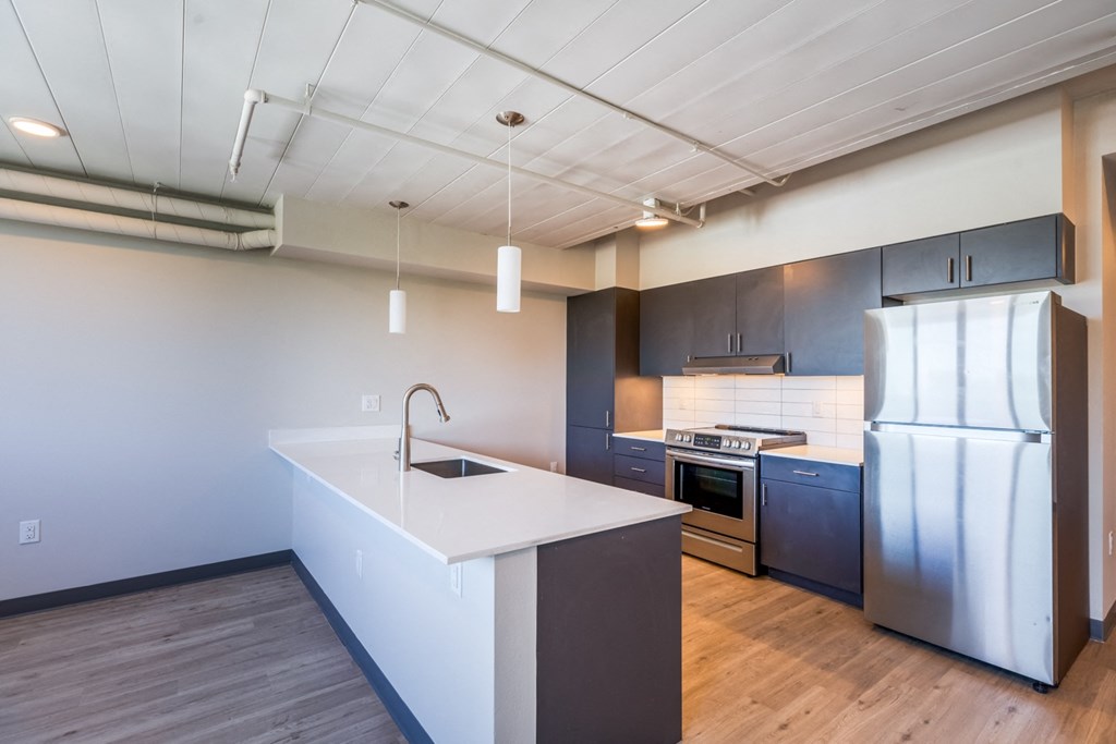 a kitchen with stainless steel appliances and a white counter top
