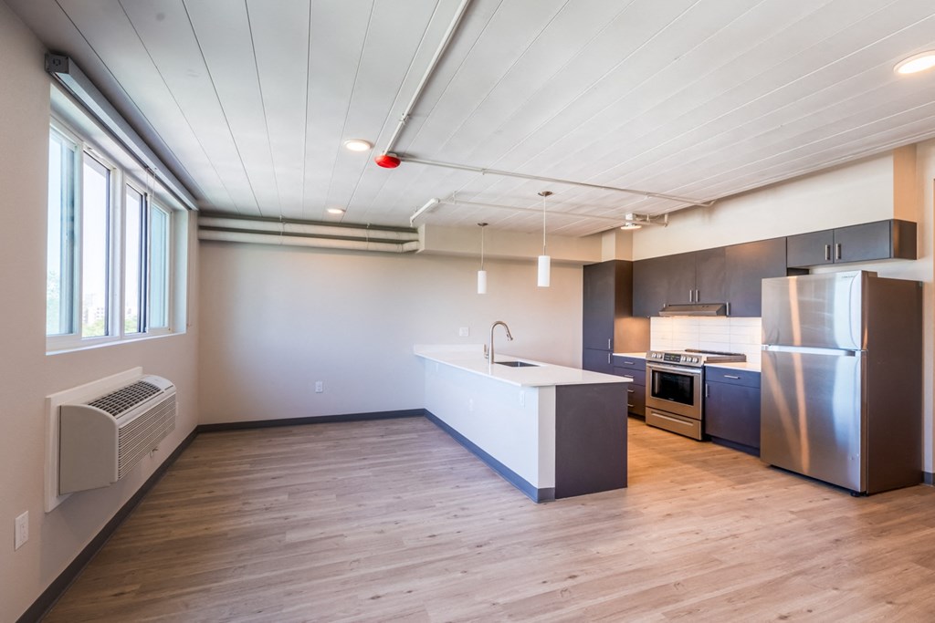 a kitchen with stainless steel appliances and a white counter top