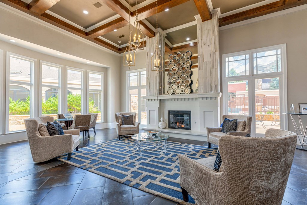 a living room with couches and chairs and a fireplace
