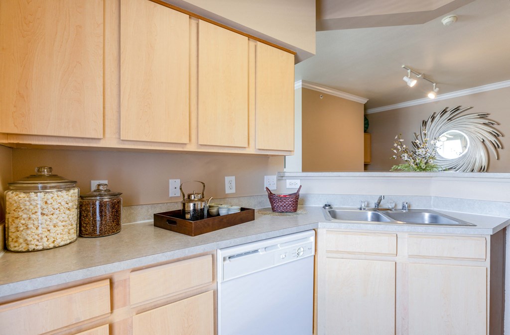 a kitchen with white appliances and wooden cabinets