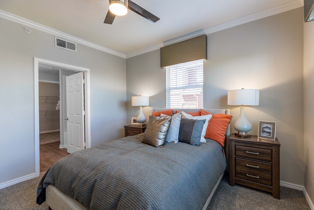 a bedroom with a bed and a ceiling fan