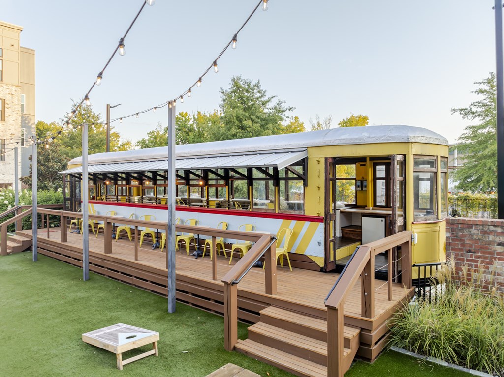 Train-themed bar with a patio and string lights