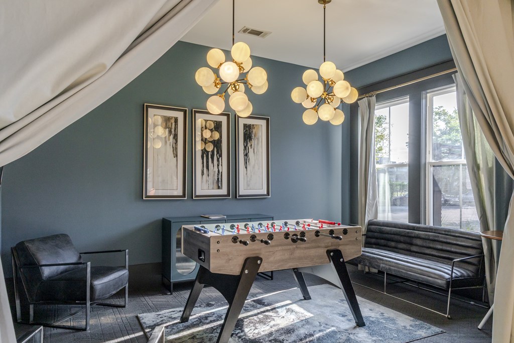 Foosball table and chairs and a couch