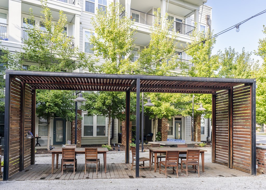 Tables and chairs underneath a large pergola