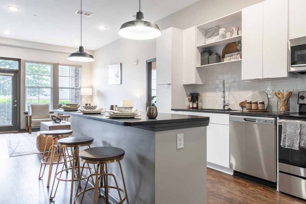 A modern kitchen with a large island and stainless steel appliances.