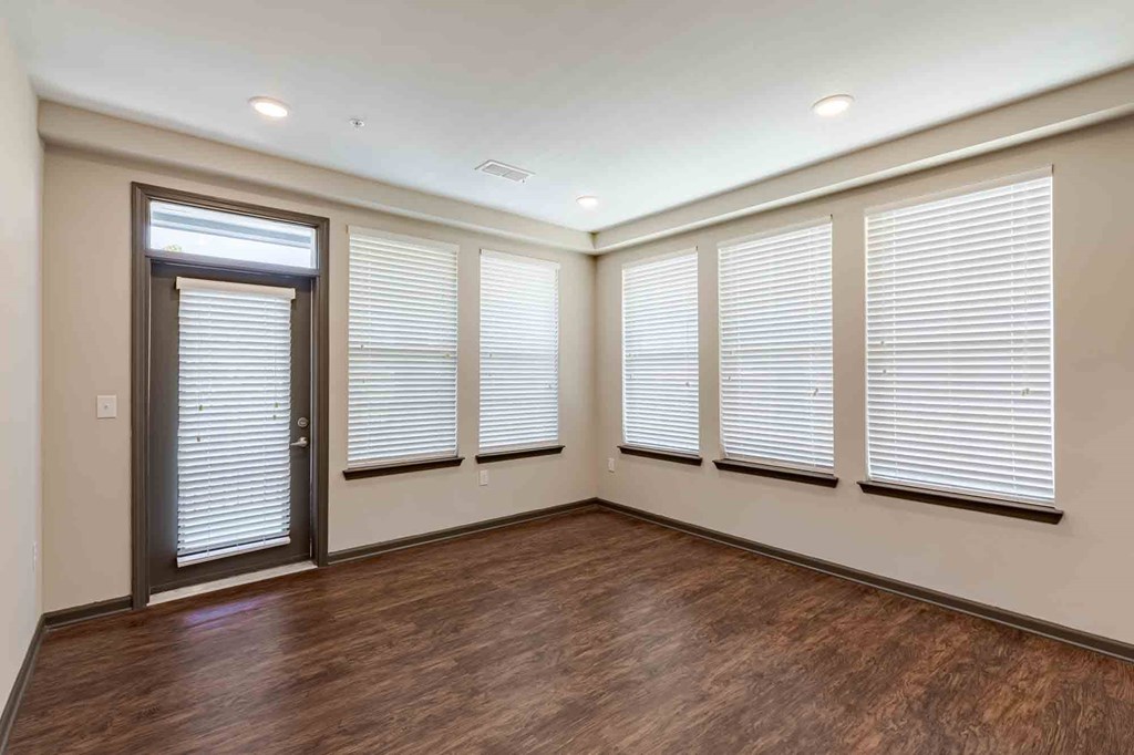 A room with wooden floors and a sliding door.