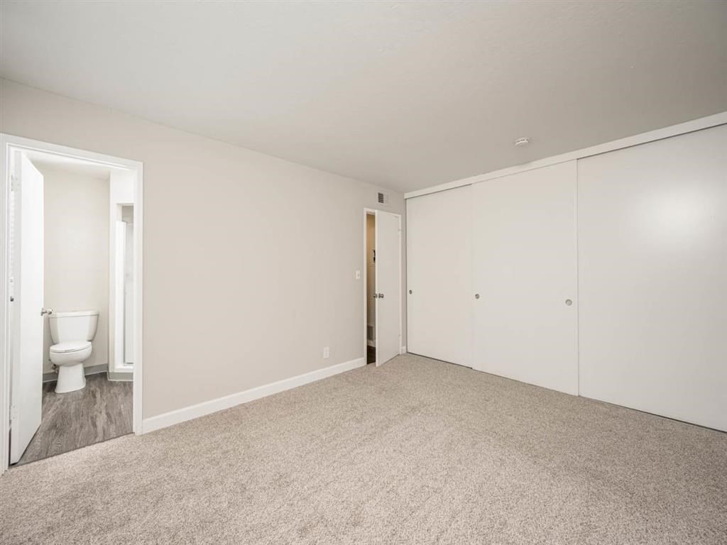 an empty room with white walls and a toilet