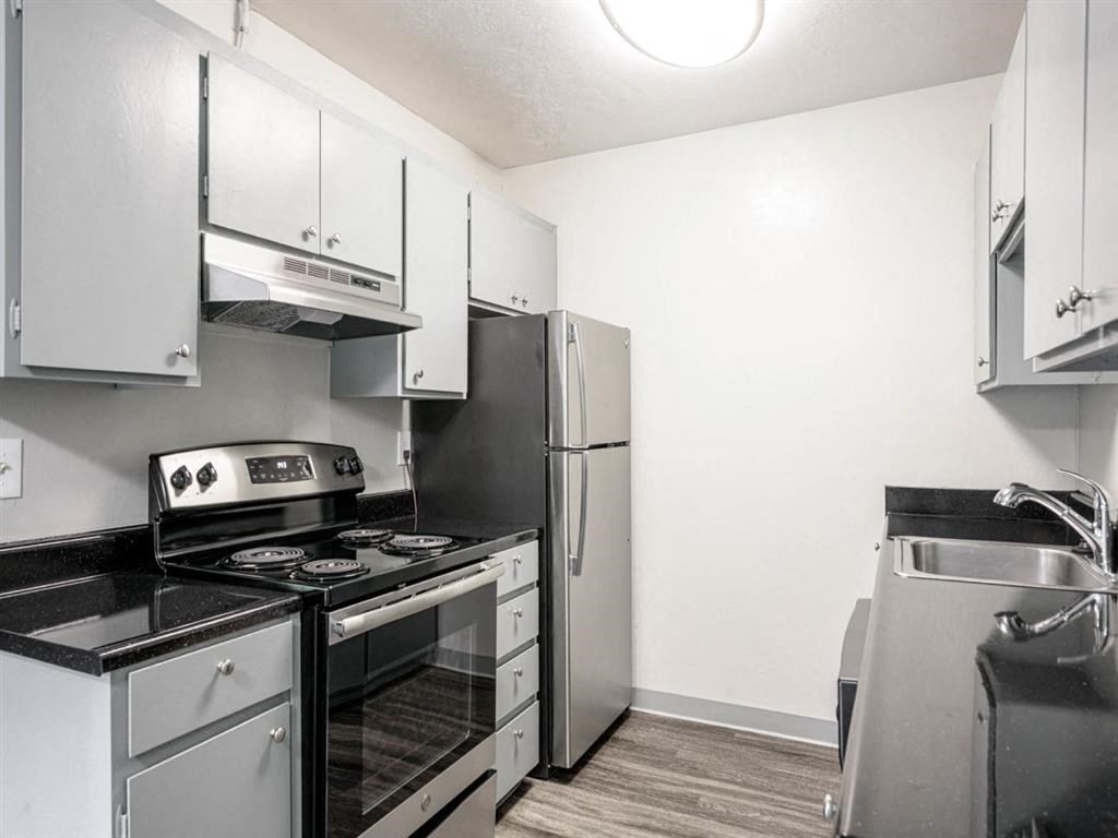 a kitchen with stainless steel appliances and white cabinets