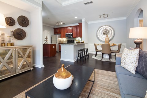 A modern living room with a black coffee table and a blue couch.