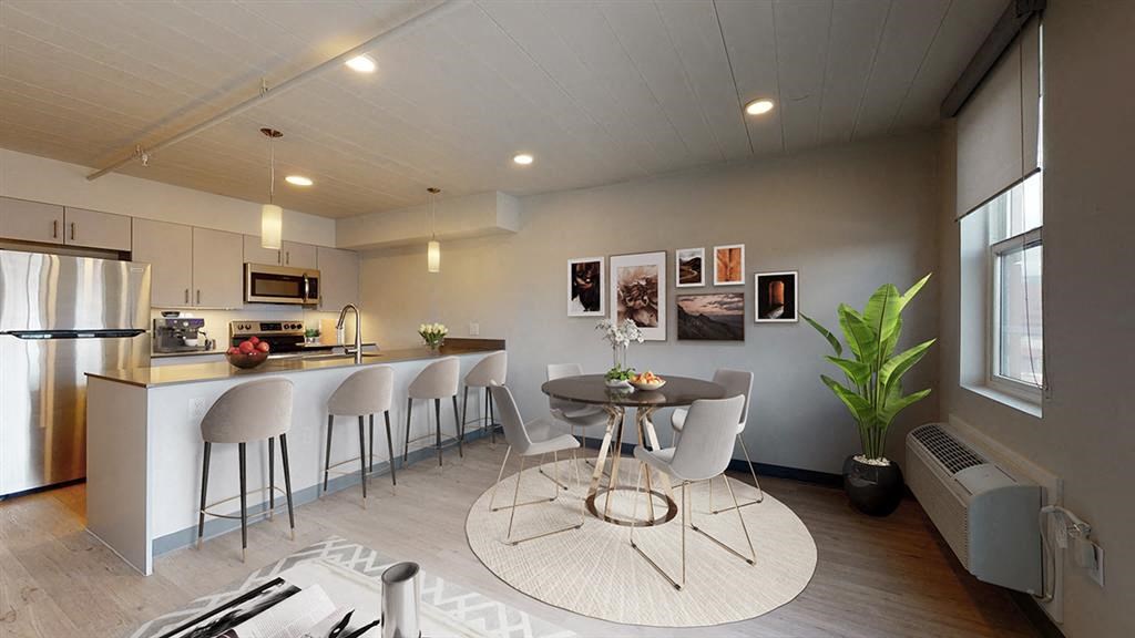 a kitchen and dining room with a table and chairs