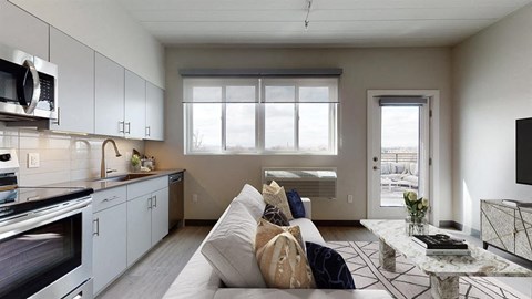 a living room with a couch and a kitchen
